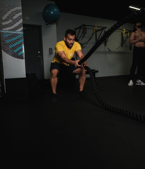 Man performing a core strength exercise in a dark, focused environment.